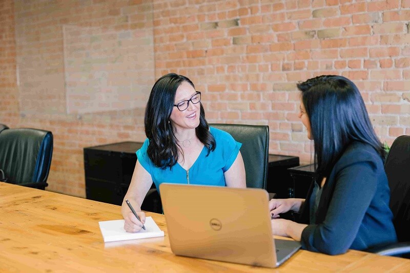 two women discussing the concept of secure password sharing