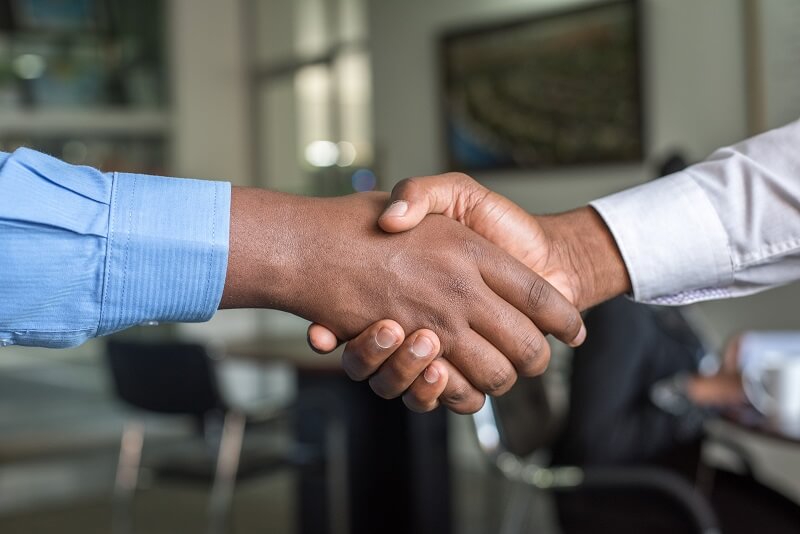 men shaking hands, searching for the best password manager for team work