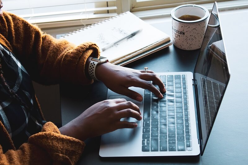 a person typing a keyboard; keylogger attack concept