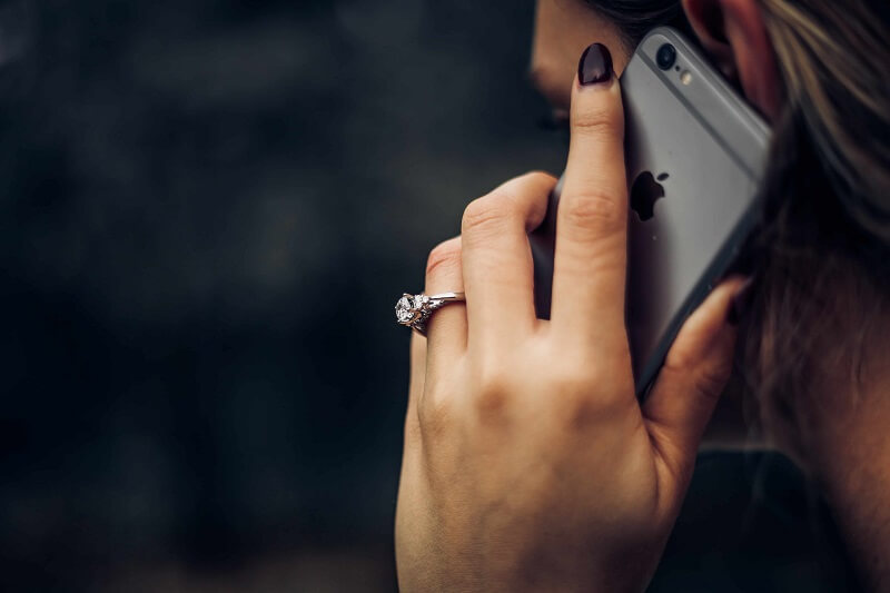 a woman talking on a phone, a possible target of vishing attack