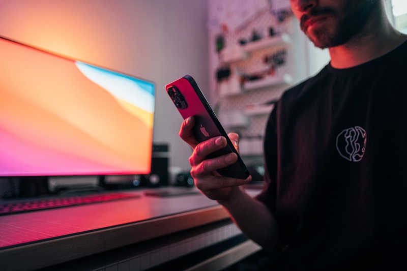 a man holding a smartphone, thinking of what to do after a data breach